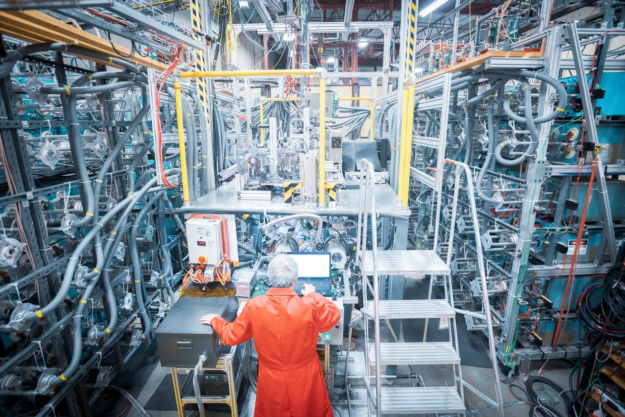 A General Fusion scientist monitors a small-scale plasma injector.